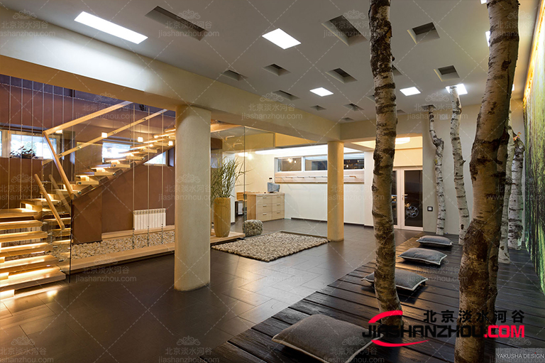 floating-stairwell-with-pillars-and-glass-panels-pebble-look-rug-and-featured-tree-trunks.jpg